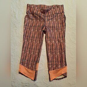 Under Armour women's size Medium cropped light orange & black leggings EUC